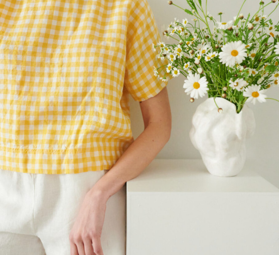 An oversized yellow gingham linen shirt wit short sleeves