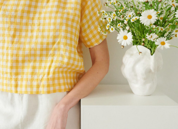 An oversized yellow gingham linen shirt wit short sleeves