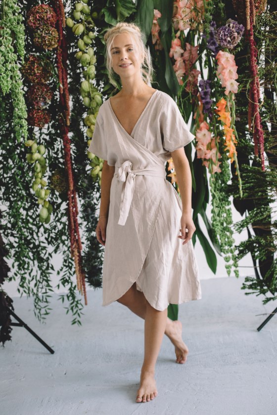 A woman wearing beige linen wrap dress