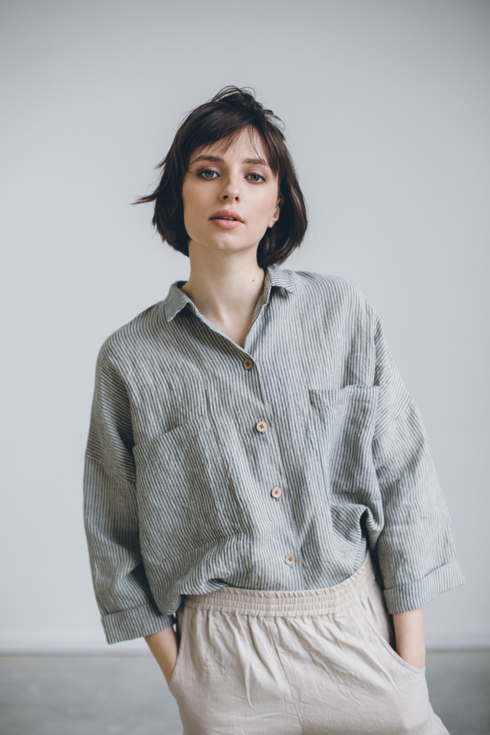 A model wearing linen grey stripe oversized shirt