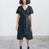 The front of the black linen dress on a woman