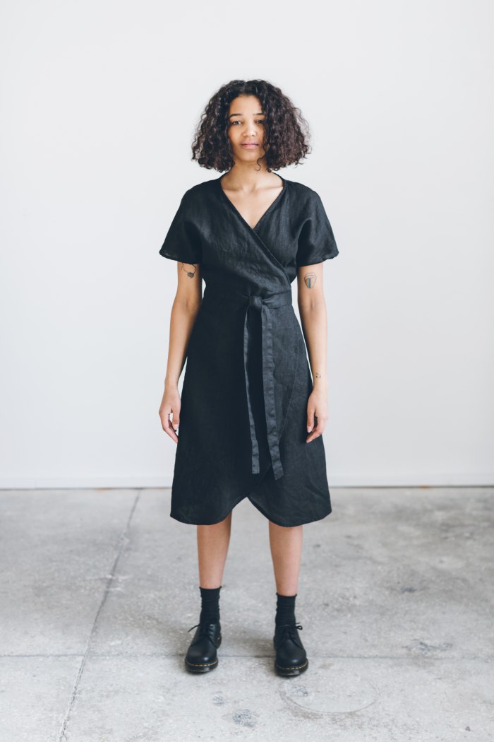 The front of the black linen dress on a woman
