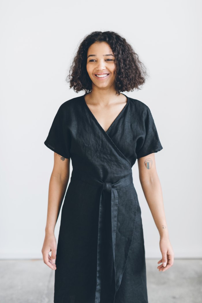 A woman wearing black linen wrap dress