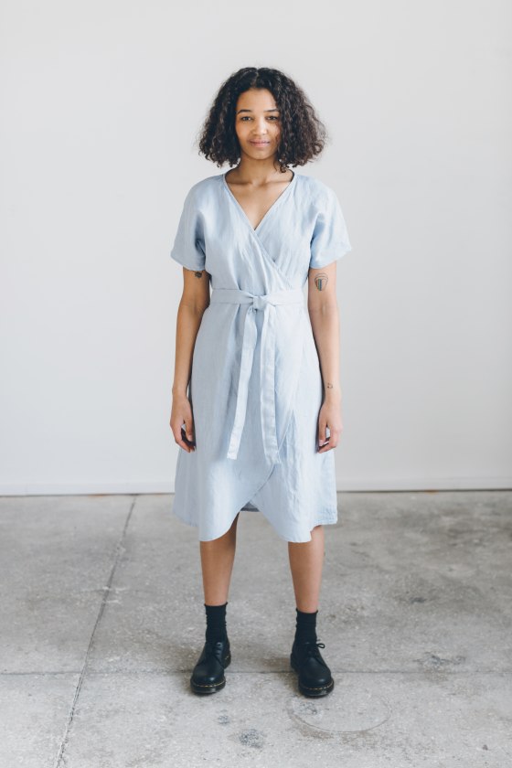 A woman in a light blue linen dress