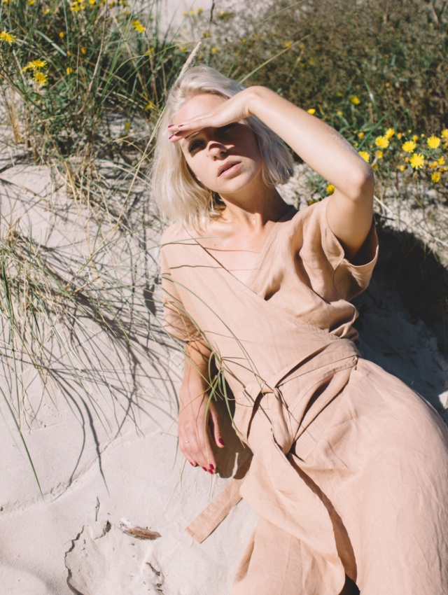 A woman in dusty peach linen oversized dress