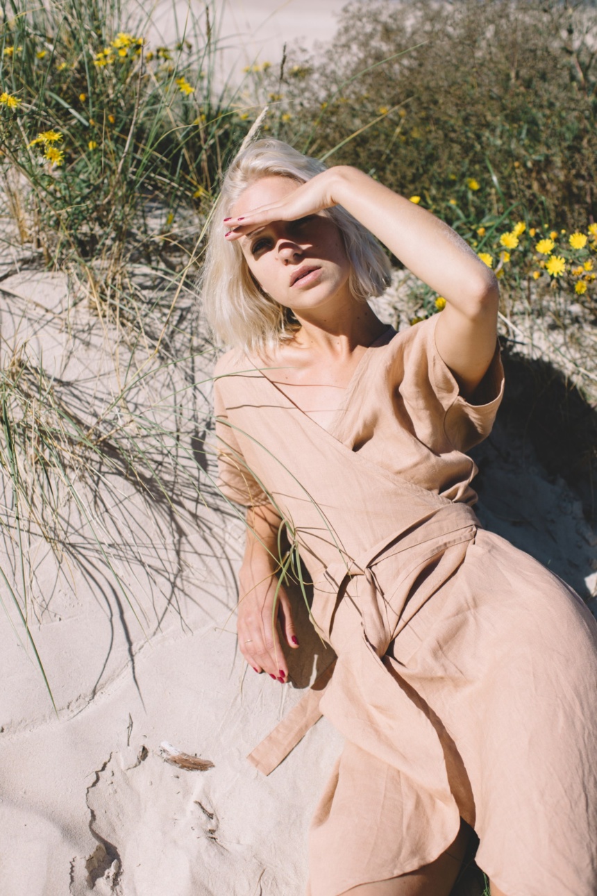 A woman in dusty peach linen oversized dress