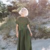 A dark green oversized linen top from the back