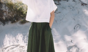 Green linen palazzo and white top set in beach