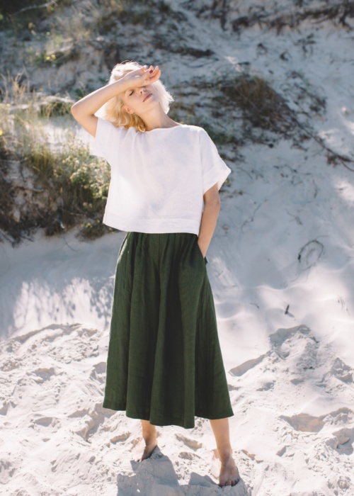 Green linen palazzo and white top set in beach