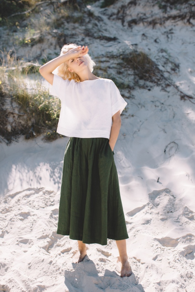 Green linen palazzo and white top set in beach