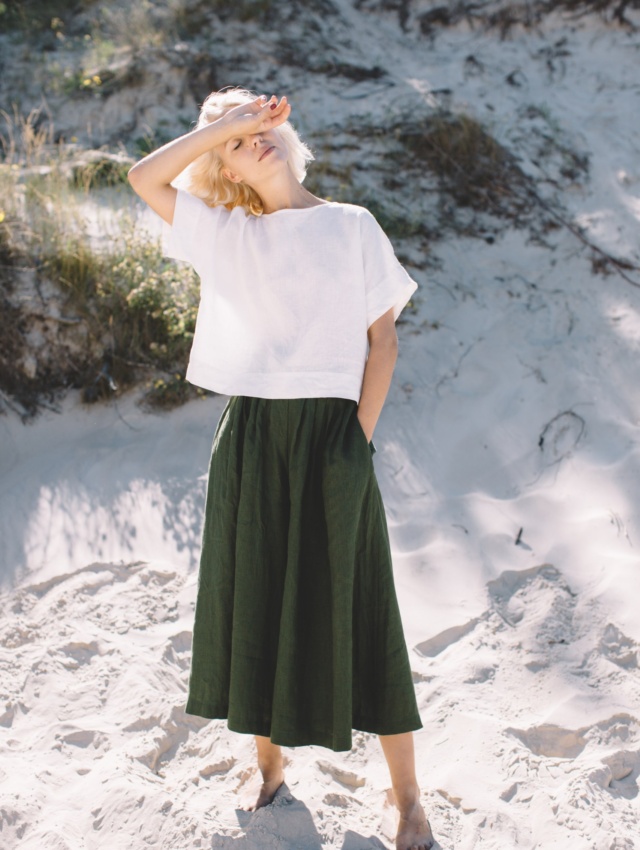 Green linen palazzo and white top set in beach