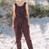 Model wearing sleeveless linen jumpsuit in beach