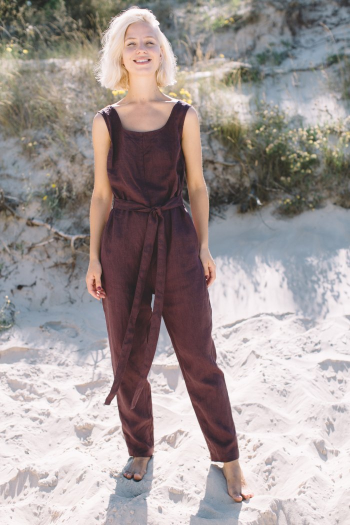 Model wearing sleeveless linen jumpsuit in beach