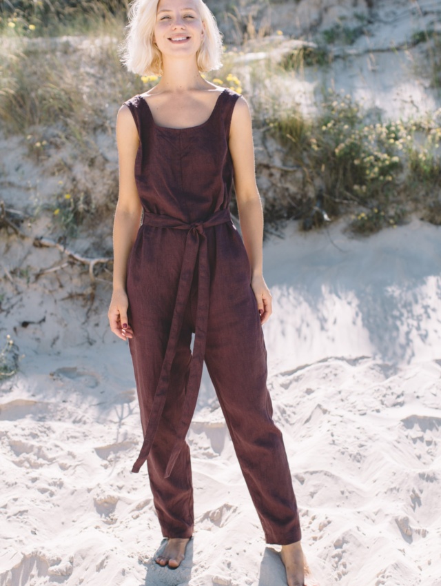 Model wearing sleeveless linen jumpsuit in beach