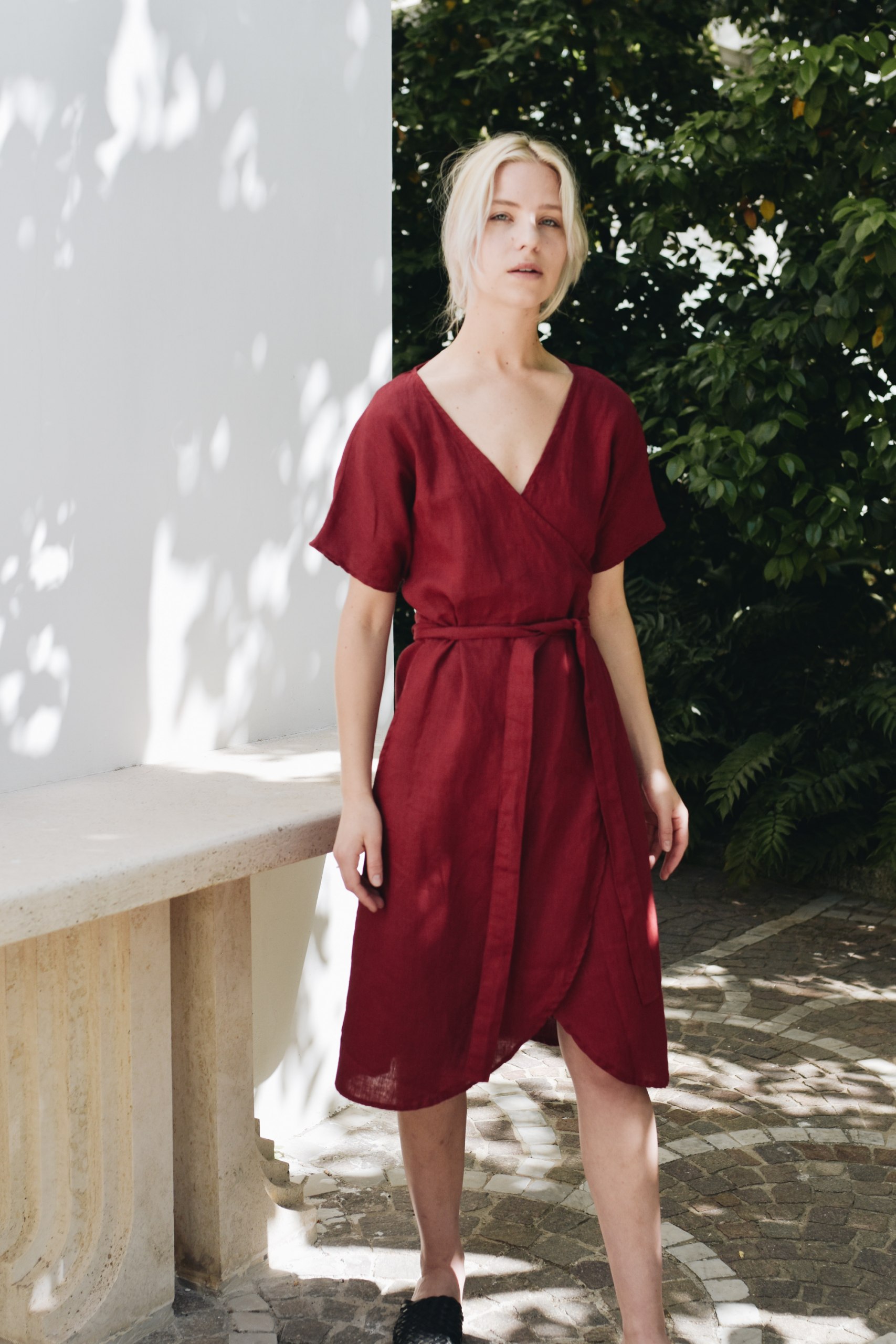 A woman wearing red linen wrap dress