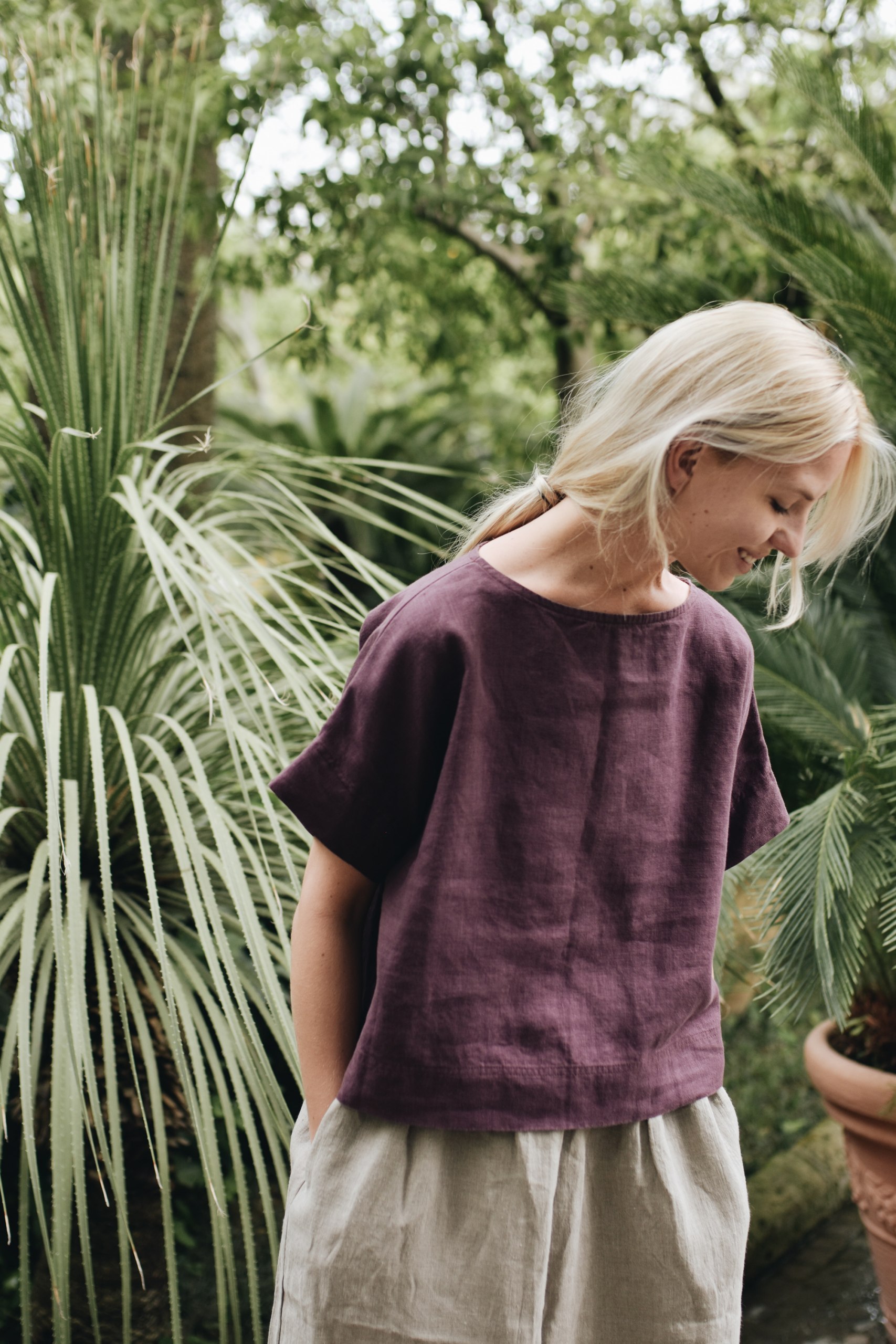 Linenfox model wearing short sleeve summer linen top in dark purple