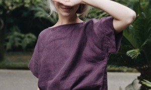 A woman wearing dark violet straight cut linen top