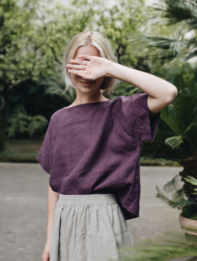 A woman wearing dark violet straight cut linen top