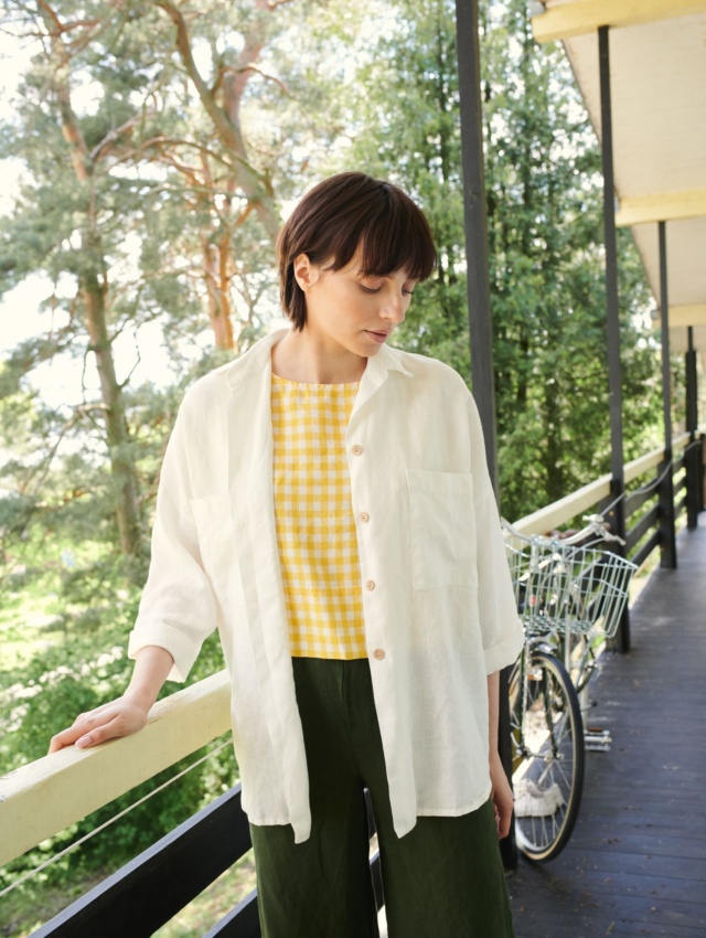 A woman in white linen button down