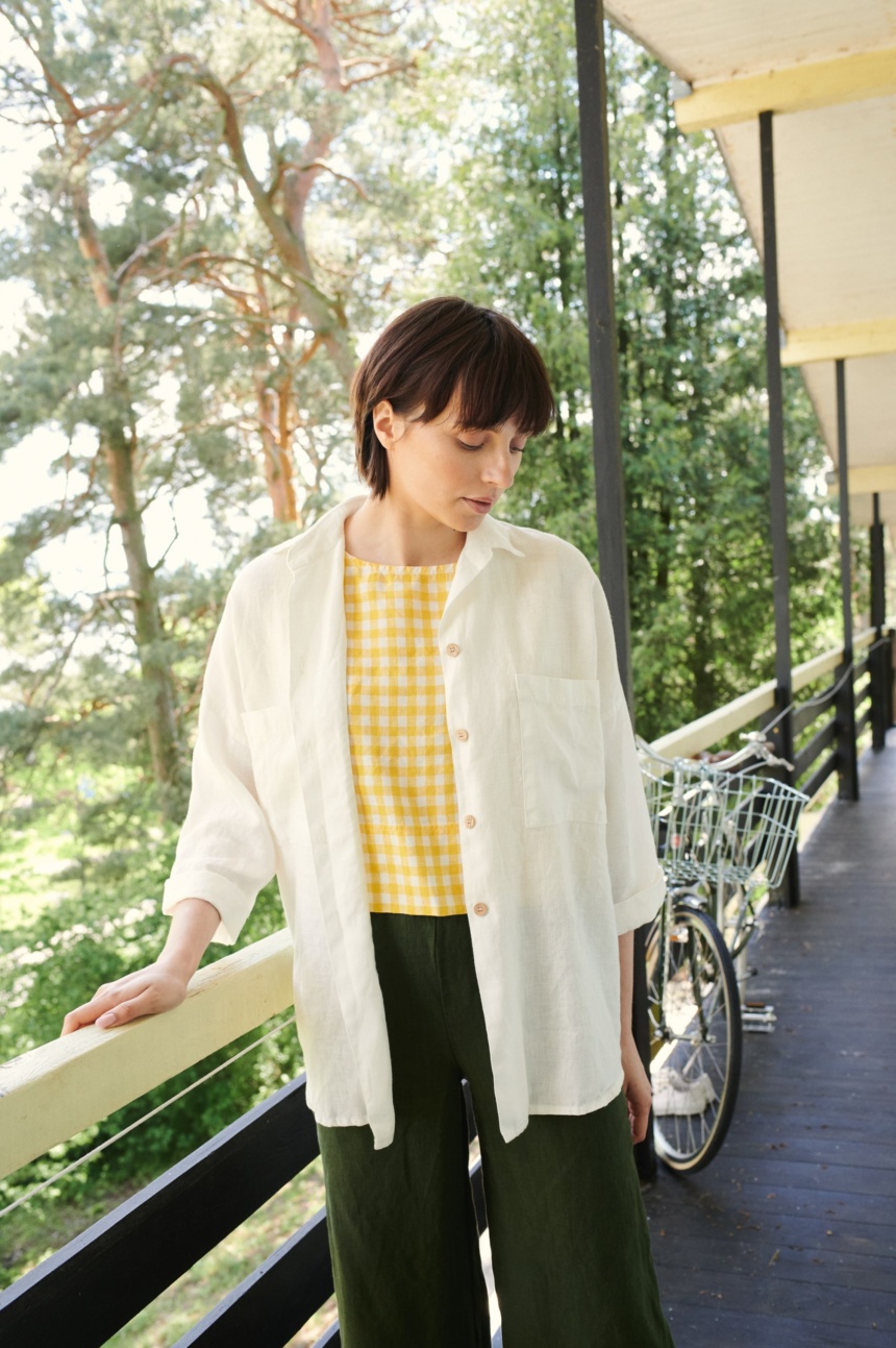 A woman in white linen button down