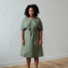 Model in a relxed fit midi linen dress with dropped shoulders