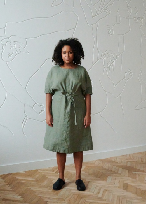 Model in a relxed fit midi linen dress with dropped shoulders