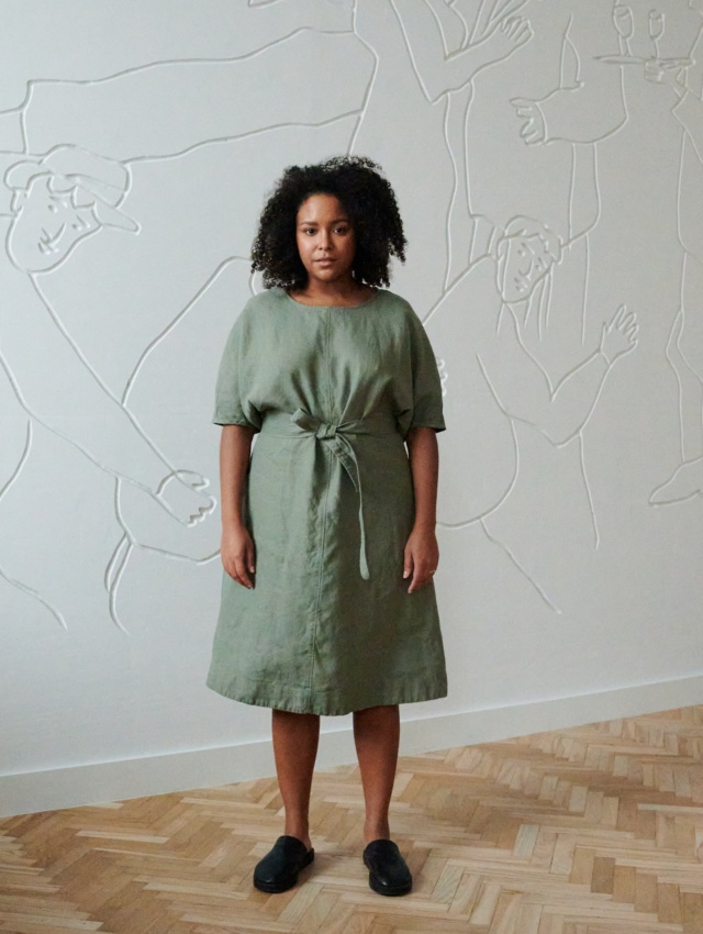 Model in a relxed fit midi linen dress with dropped shoulders