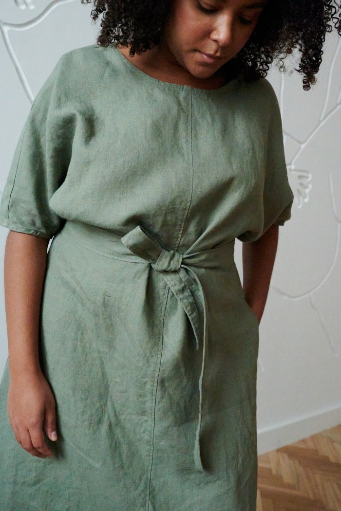 An oversized linen dress with wide sleeves and a belt