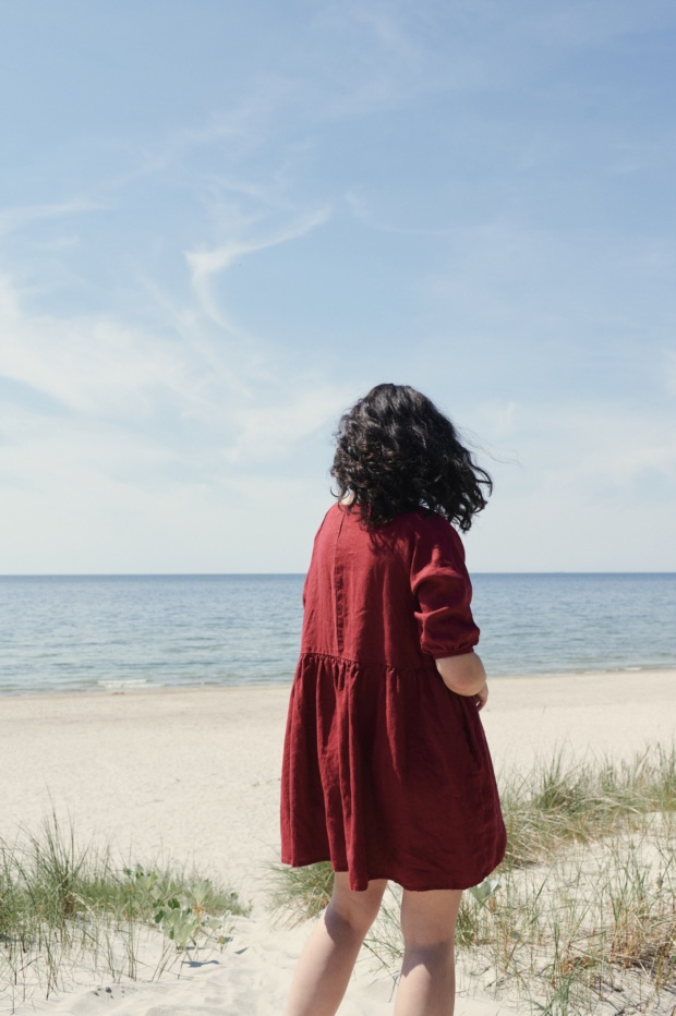 Women enjoying beach in burgundy red dress