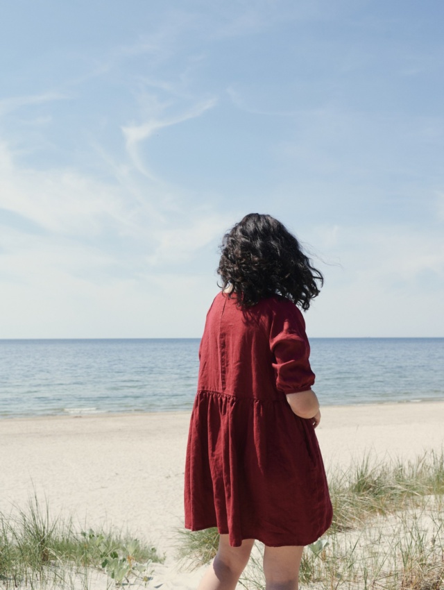 Women enjoying beach in burgundy red dress