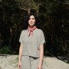 Linenfox model wearing a short sleeve summer linen top in natural grey