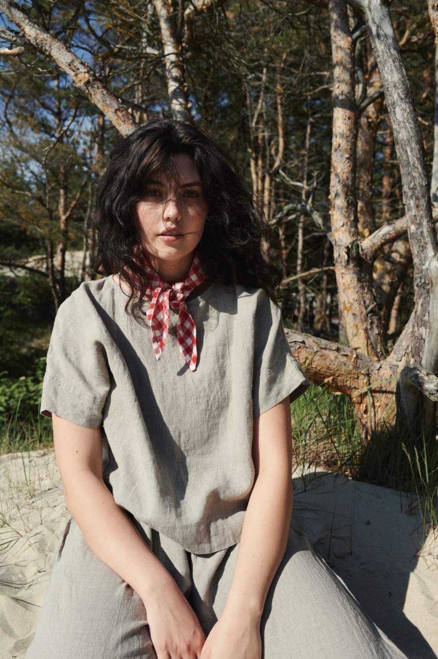 A woman wearing straight cut linen top in natural grey