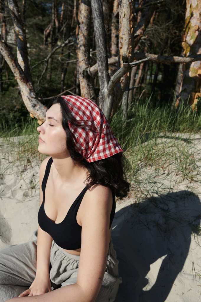 model wearing red gingham bandana
