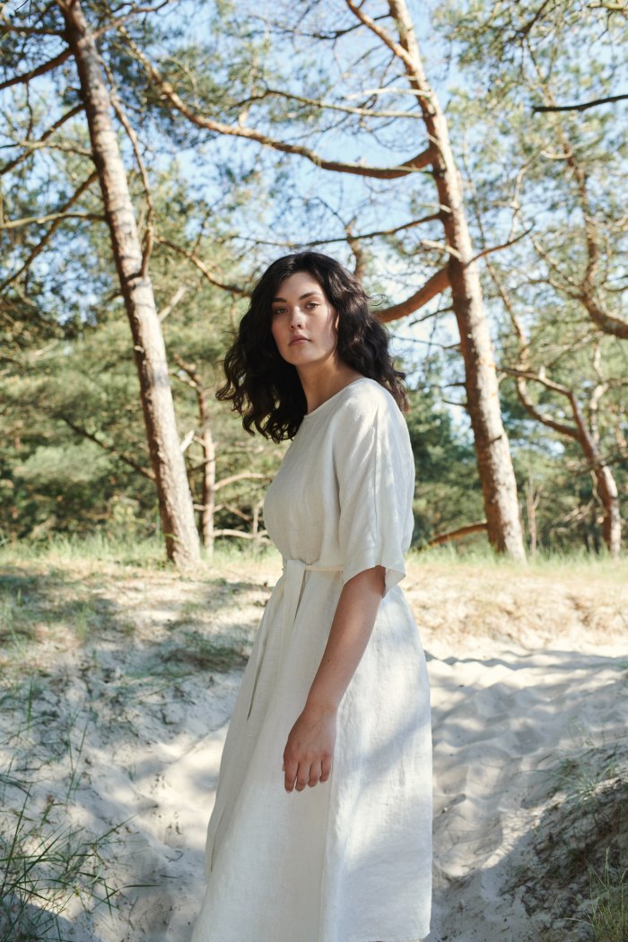Model wearing beach linen dress in white color
