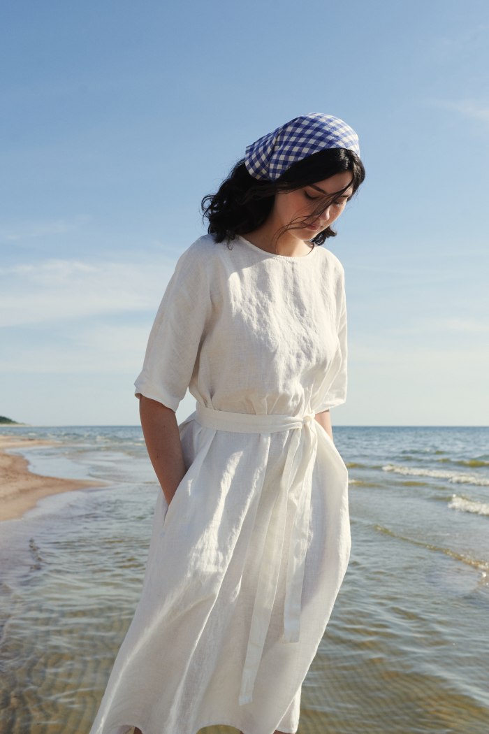 Model wearing maxi white linen dress