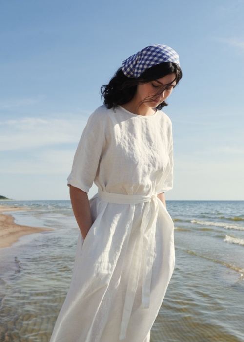 Model wearing maxi white linen dress