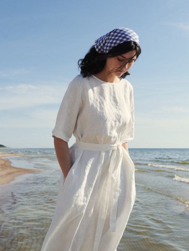 Model wearing maxi white linen dress