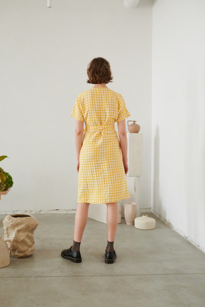 a woman's back in gingham linen wrap dress
