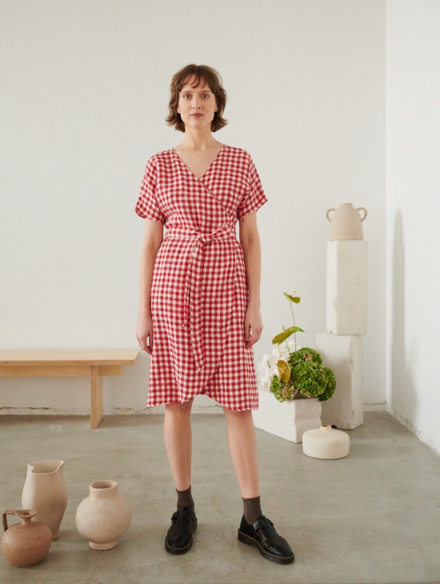 A woman wearing red gingham linen dress