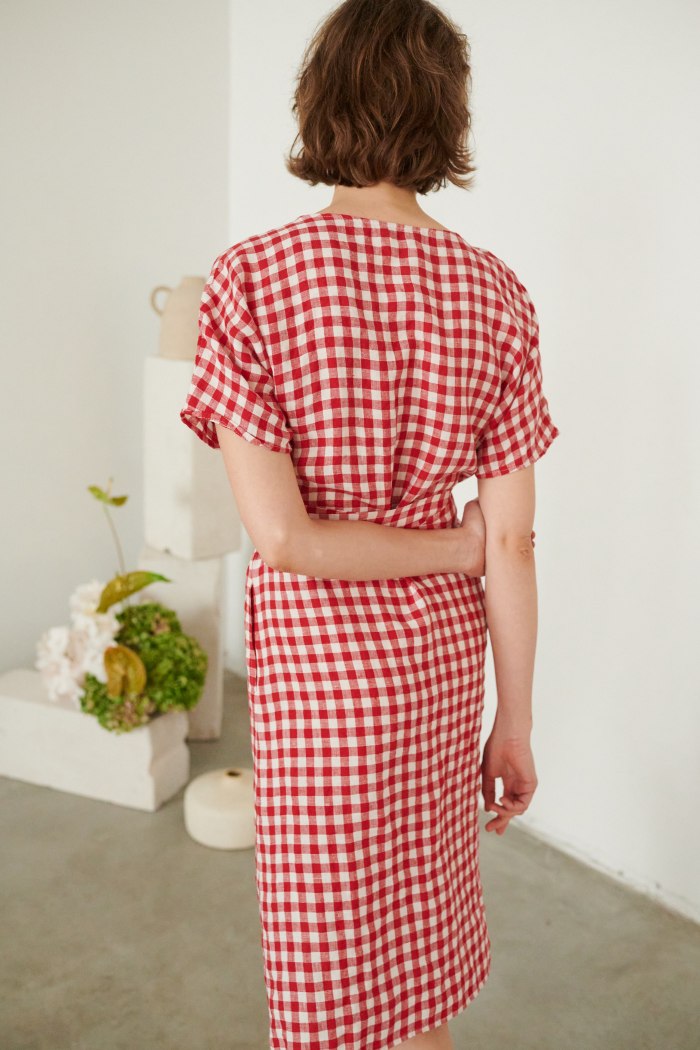 back of a woman in red gingham wrap dress