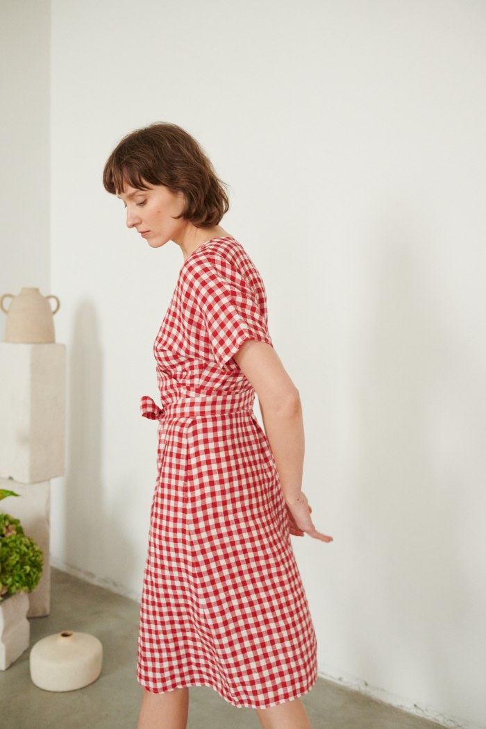a woman in red gingham linen dress