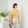 A woman in yellow gingham oversized linen top
