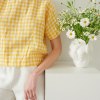 A model wearing boxy short sleeve linen top in yellow gingham