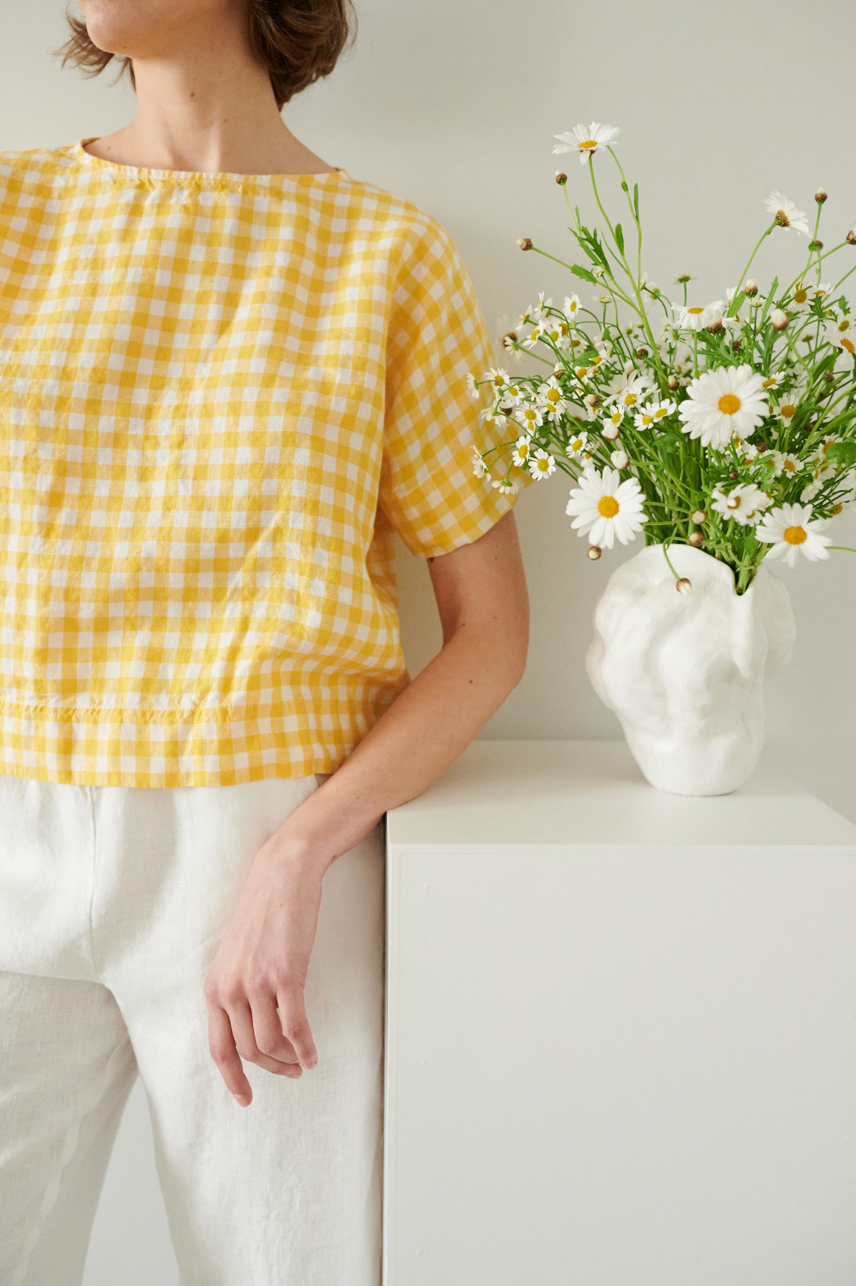 A model wearing boxy short sleeve linen top in yellow gingham
