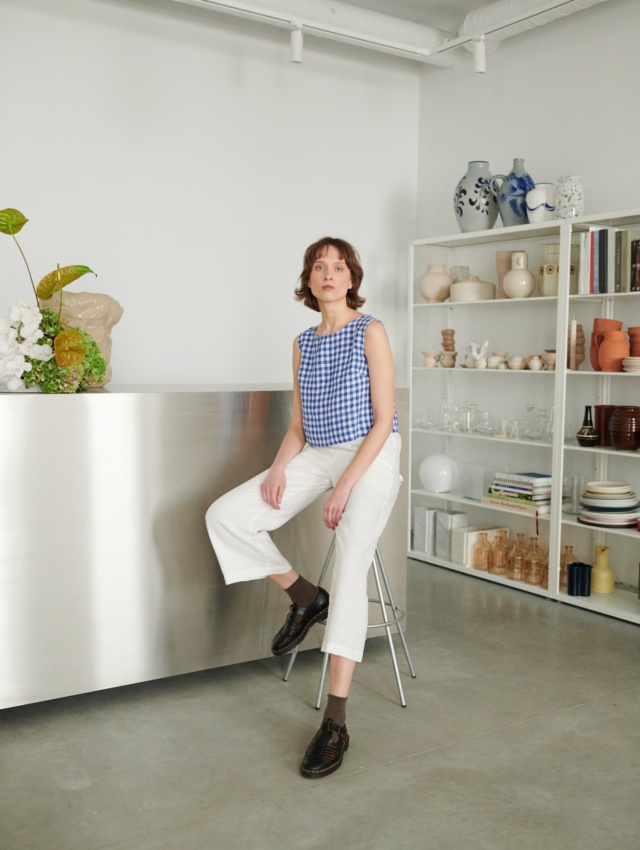 Women wearing crop blue gingham top with white pants