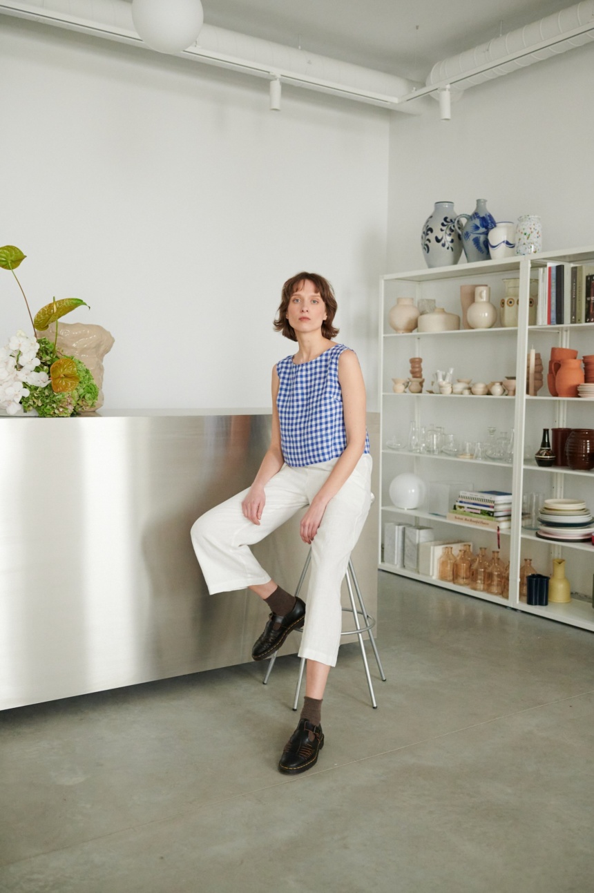 Women wearing crop blue gingham top with white pants