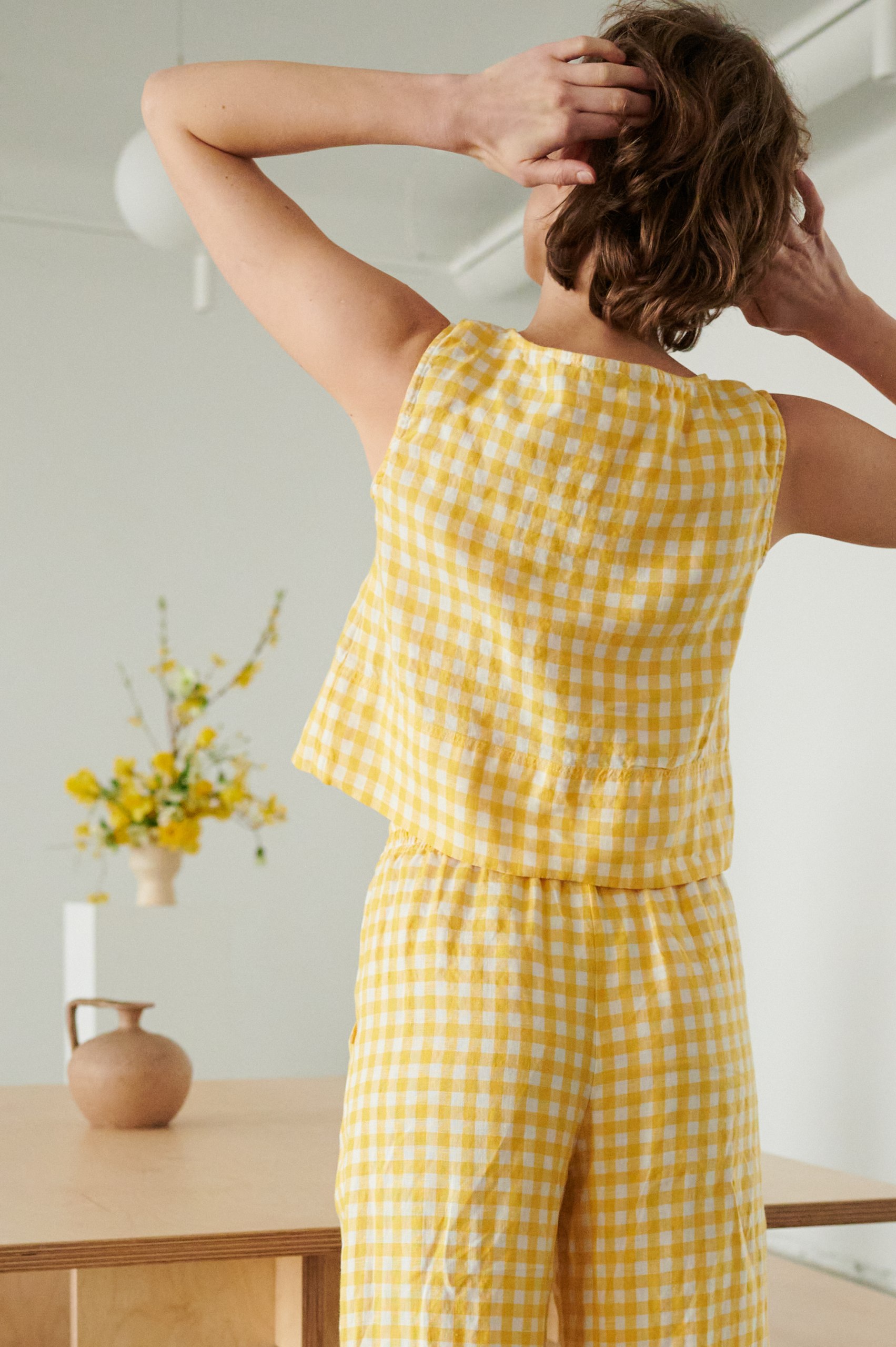 The back of high waist yellow gingham trousers