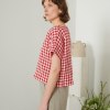 Linenfox model wearing a short sleeve boxy linen top in red gingham