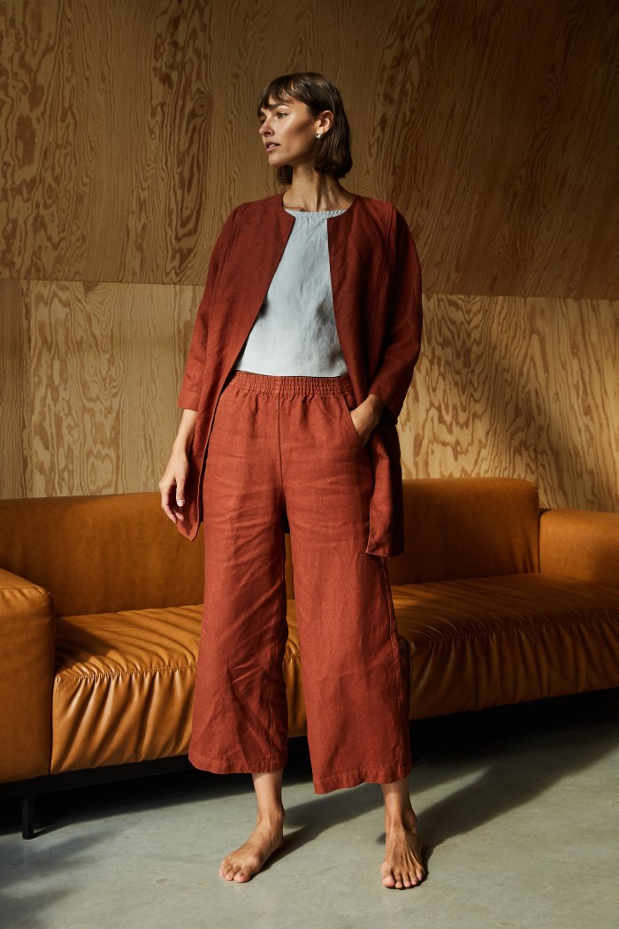 Terracotta brown heavy linen high waist trousers on a woman