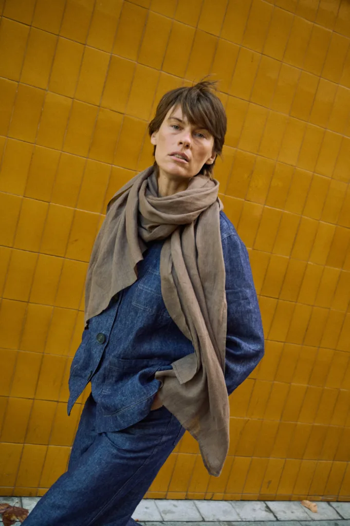 women is wearing brown light weight scarf and denim blue linen jacket